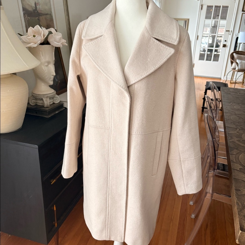 Wool blend coat with detachable faux fur collar.